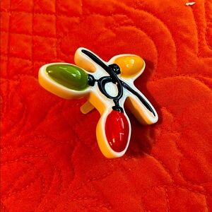 Nora Fleming plug in ornament that fits Nora Fleming products.   Brand new